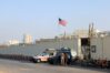 Security personnel stand outside the US Consulate in Karachi after visa services were suspended due to violent protests in Pakistan.